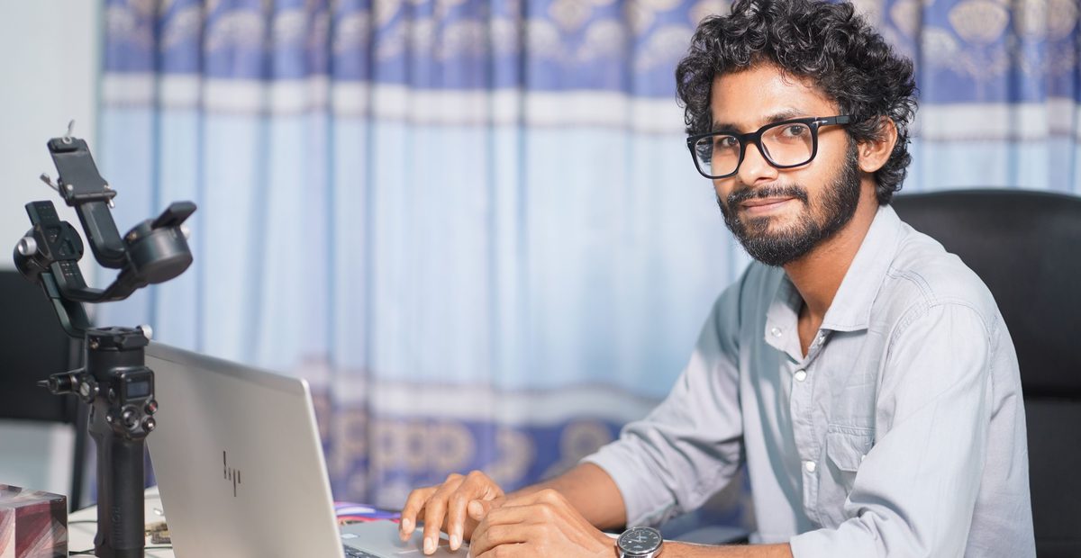 Web designer reviewing a small business website on a laptop at a desk